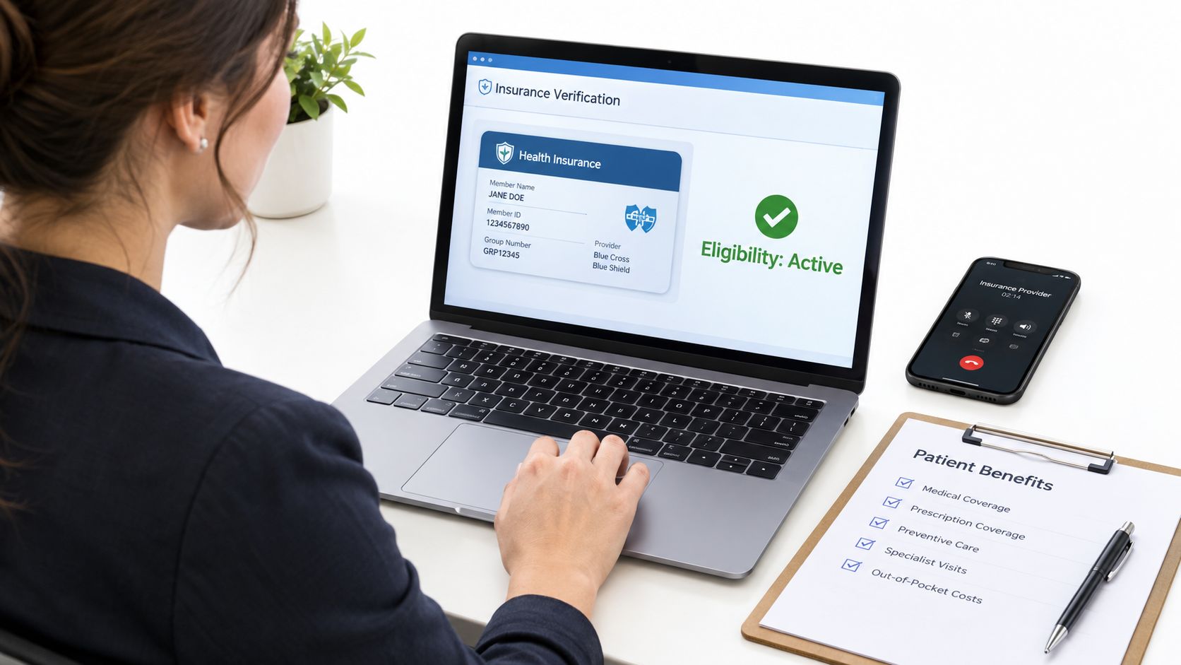 A professional receptionist checking health insurance eligibility on a laptop at a bright office desk.